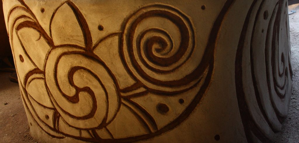 Carving spiral detail into fresh plaster